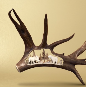 Antler with a miniature landscape inside on a beige background