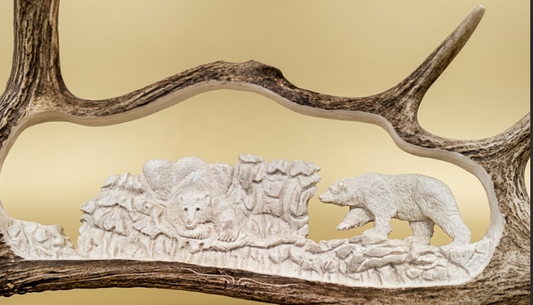 Carved scene of bears on a wooden plaque with antlers
