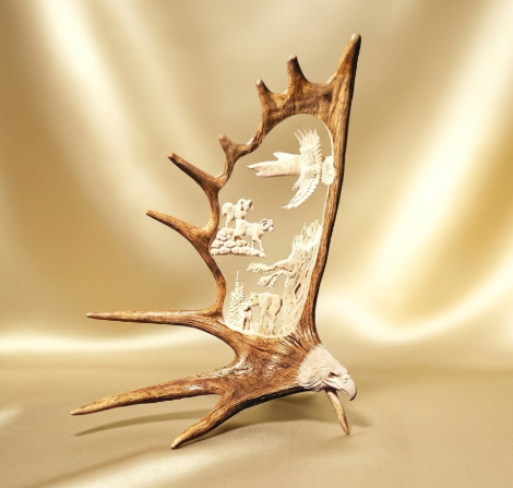 Decorative antler with carvings of animals on a beige background