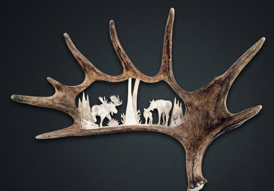 Decorative wall art with deer antlers featuring cut-out silhouettes of deer on a dark background
