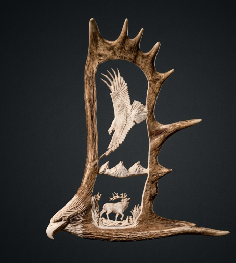 Decorative antler with carvings of an eagle and deer on a black background