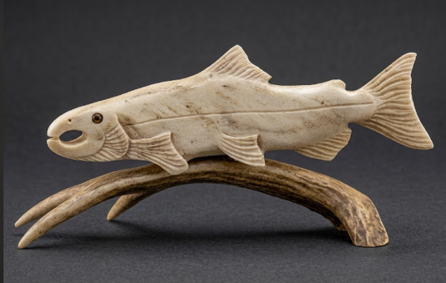 Carved fish figure on a dark background