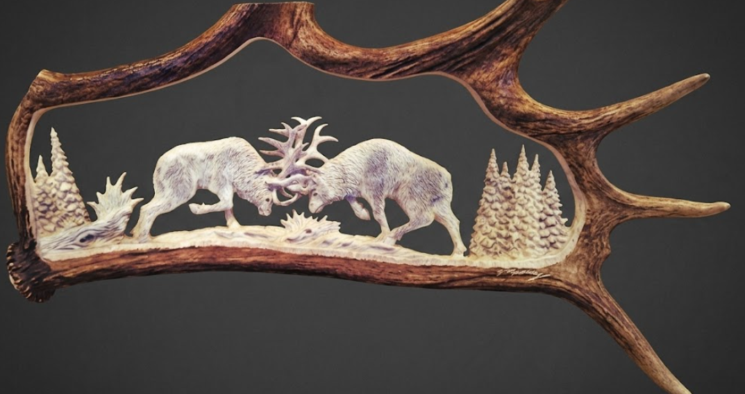 Decorative antler with carvings of animals and trees on a dark background
