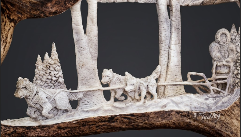 dog sled team antler carving on a grey background 