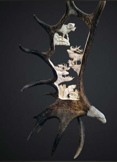 Ram, elk, moose  and a black bear  hand carved into a moose antler depicting Idaho's big 4 wild animals.