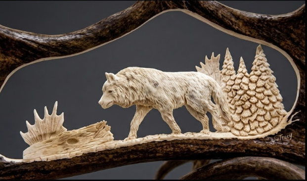 Individually hand carved moose antler wolf and forest scene on a dark background