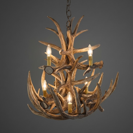 faux deer Antler chandelier with four lights on a dark background