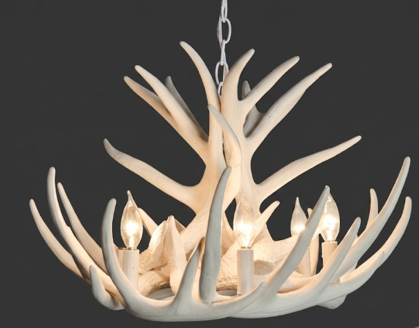 faux deer Antler chandelier with four light bulbs on a dark background