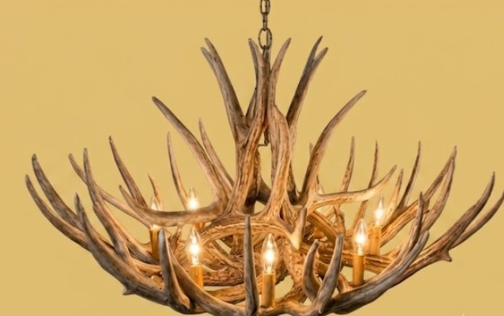 faux deer Antler chandelier with multiple lights on a beige background