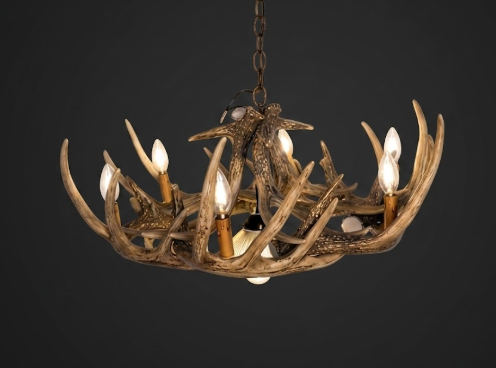 faux deer Antler chandelier with multiple lights on a dark background