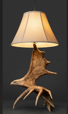 Lamp with a large antler-like fixture on a dark background