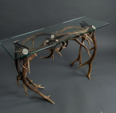 antler sofa table Glass-top sofa/console table  with antler design with dark walls