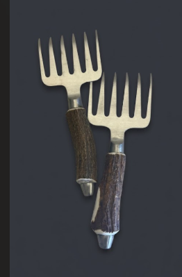 Two metal forks with wooden handles on a dark background