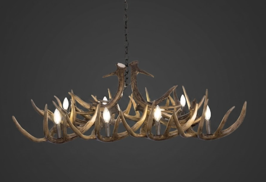 faux deer Antler chandelier with lights on a dark background