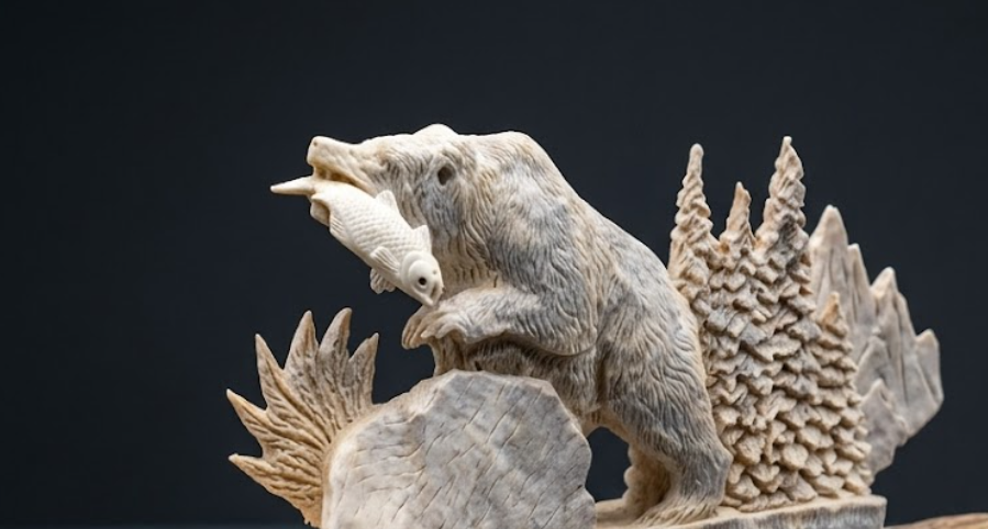 Carved stone sculpture of a bear with fish on a dark background
