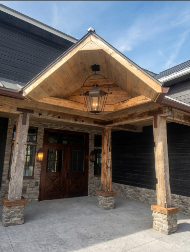 Foyer entry way dark copper outdoor pendant light near a wood wall and door