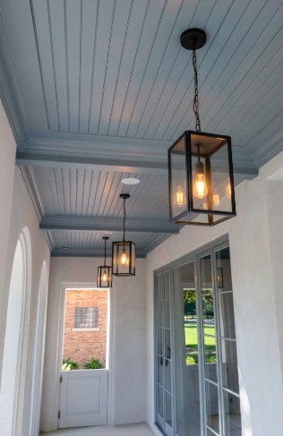 Ceiling with 3 decorative entryway pendant light fixtures in a home interior.