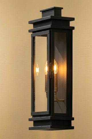 Black outdoor wall light fixture on a beige background