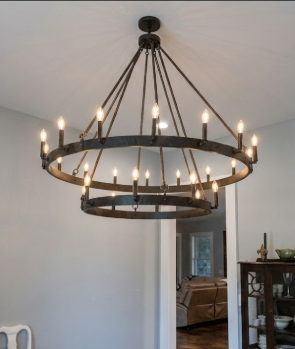 Large round foyer entryway light chandelier hanging in a room with a neutral color scheme.