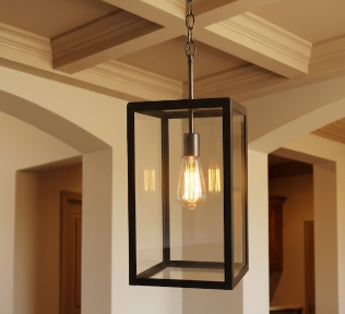 Decorative foyer entryway pendant light with a black metal frame on a beige background