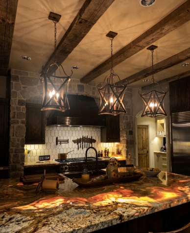 Modern kitchen with stone walls, granite countertops, and foyer or entryway kitchen island pendant light or chandeliers.