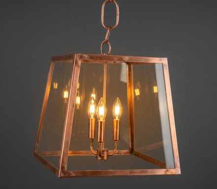Copper foyer kitchen island pendant light fixture with glass cover on a dark background