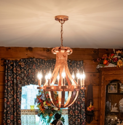 Copper foyer entryway kitchen island pendant light or chandelier hanging in a room with floral curtains and decorative items.