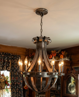 Vintage-style copper foyer entryway kitchen island pendant light or chandelier hanging in a room with wooden walls and decorative elements.
