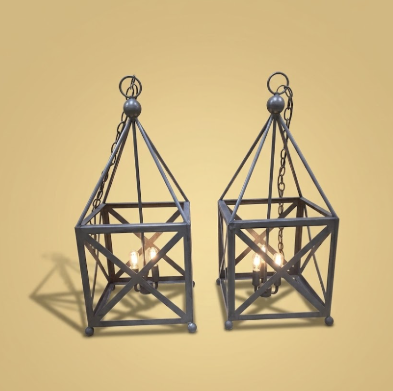 2 copper foyer entryway kitchen island pendant lights or chandeliers sitting on a floor for display