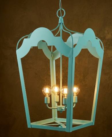 Turquoise pendant light fixture with three visible bulbs against a brown background