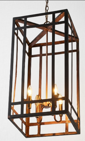 Decorative foyer or entryway pendant light or chandelier with metal frame and three lights on a white background