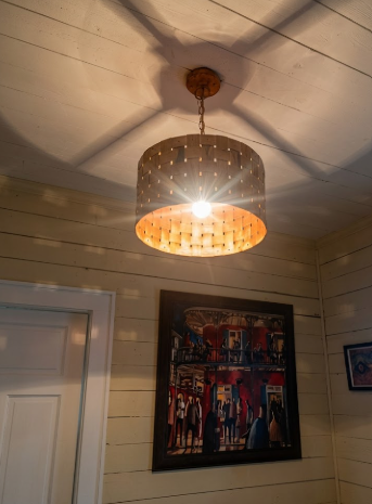 Copper kitchen island pendant lights or chandeliers in a modern interior in a room with framed artwork on the wall.