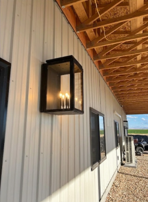 Modern outdoor light fixture on a building exterior with wooden ceiling