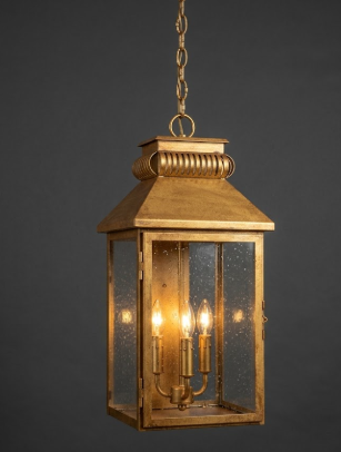 Copper pendant light lantern with glass panels on a dark background