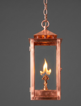 Raw copper lantern-style pendant llight fixture on a beige background