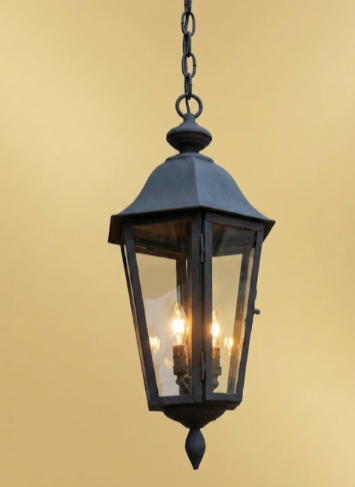 Black lantern-style outdoor pendant  light fixture on a beige background