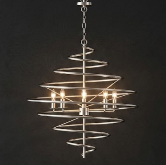 A modern spiral chandelier with a brushed silver metal frame and five lit candle-style bulbs, suspended against a dark charcoal background.