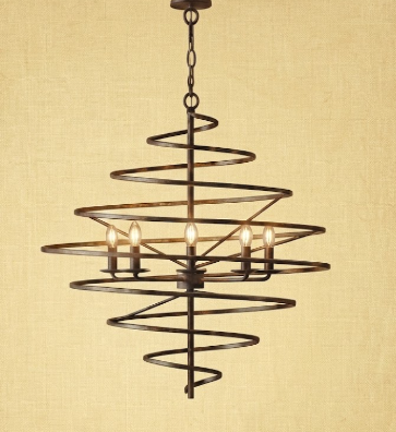 A spiral metal chandelier with five tiers of concentric rings and five lit candle-style bulbs, shown against a warm beige textured background.