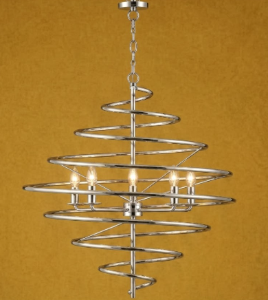 A spiral-shaped modern chandelier with a polished chrome finish and six lit candle-style bulbs, shown against a textured mustard yellow background.